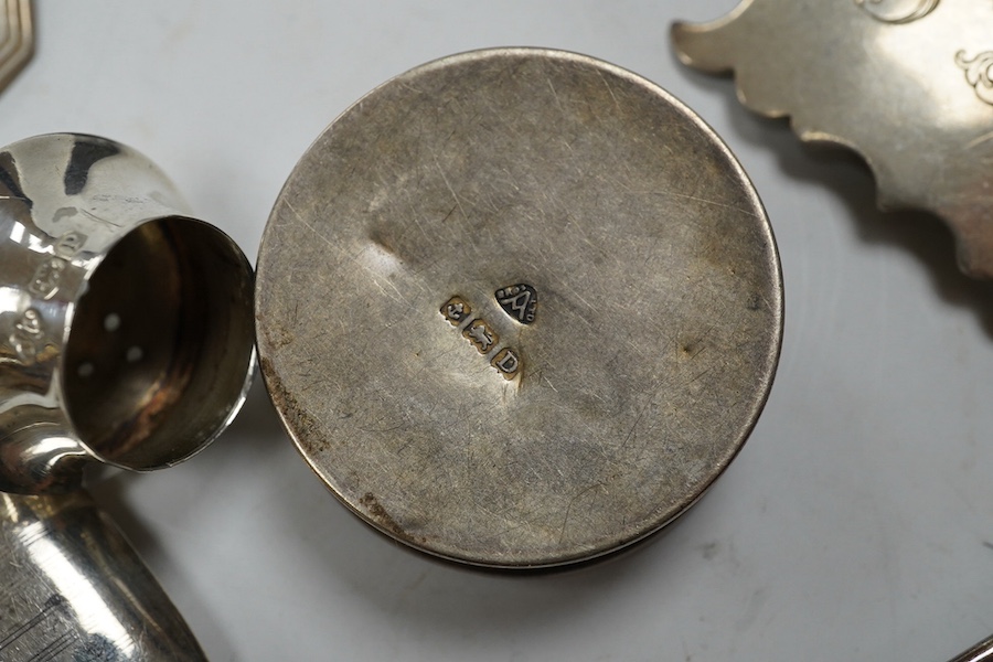 Assorted small silver items including two vesta cases, caddy spoons, mustard ladles, enamelled pill box, wine labels etc. Condition - poor to fair to good